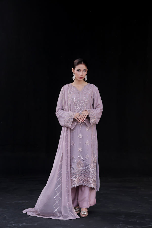 Woman wearing a lavender purple embroidered SAFFRON outfit
