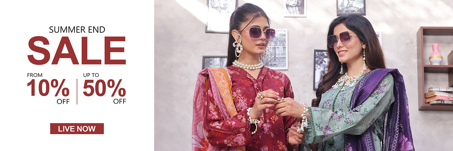 Two women in traditional attire with a summer sale banner